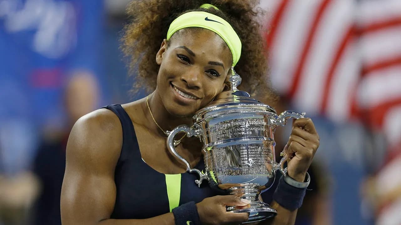 Serena Williams holding the US Open trophy.